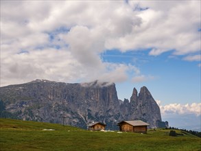 Alpine huts in front of the Sciliar, Punta Santner, Dolomites, Alpe di Siusi, South Tyrol, Italy,