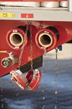 Close-up of fire engine with open water connections and dripping water, fire brigade, Enzklösterle,