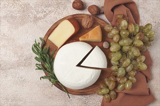 Georgian cheese, Imeretian and smoked suluguni, grapes, nuts, on a cutting board, Georgian cuisine,