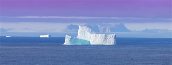 Iceberg seen from cruise ship vacation near Greenland coast in Arctic circle near Ilulissat Disko