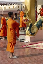 Monk in front of a Buddha statue, Bhumispara-mudra, Buddha Gautama at the moment of enlightenment,