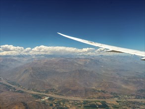 Aeroplane wing with view over the Andes, Chile, South America