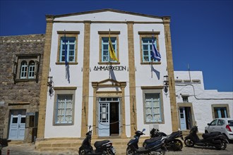 Town Hall, Historic white building of the municipal administration with flags and parked