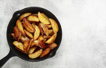 Fried potato slices, in a cast-iron pan, homemade, no people