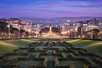 View of Lisbon Marquis of Pombal Square seen from the Eduardo VII Park in the evening twilight.