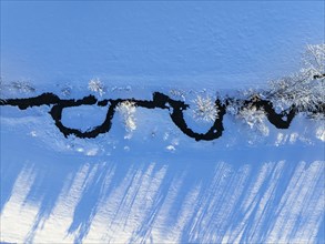 Aerial view of a small stream in the snow, Alpine foothills, Upper Bavaria, Bavaria, Germany,