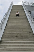 Lonely ten-year-old boy with his football, stairs to the viewing platform of the Chocolate Museum,