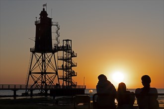 Sunset, lighthouse Obereversand, silhouettes, people, North Sea, Dorum-Neufeld, Wurster Land, Lower