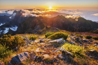 View of mountains over clouds from Pico Ruivo on sunset. Madeira island, Portugal, Europe