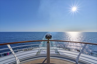 View from the ship's deck, Mein Schiff 6, under bright sunshine and blue sky, binoculars attached