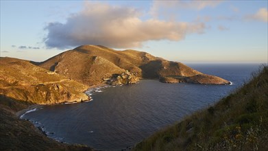 Sunset on a mountainous coastline with reflecting sea and clouds in the sky, southern tip, Mani