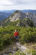 View over the mountain ridge of the Schindergebirge to the Bavarian Schinder, mountaineer on hiking