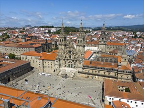 An aerial view of a cathedral and red roofs of a historic cityscape in sunny weather, Cathedral,