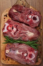 Raw steak, calf's neck on the bone, fresh meat, on the cutting board, top view, no people