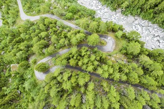 Aerial view, drone shot, windy road along a river, mountain valley, Switzerland, Europe