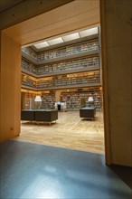 Interior of a modern library, open and bright with numerous bookshelves and reading areas, Weimar,