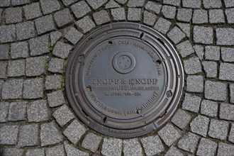 Advertising on a municipal manhole cover, Villingen-Schwenningen, Baden-Württemberg, Germany,