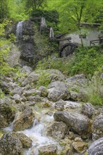 Stream, mill wheel and waterfall at the old mill, Tramonti di Sopra, province of Pordenone, Italy,