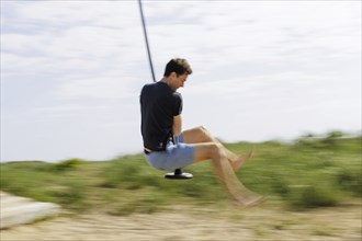 Man on a cable car on a children's playground on the North Sea island of Borkum, 18/05/2024