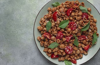 Tuscan pasta with smoked paprika and basil, parmesan cheese, Italian traditional cuisine