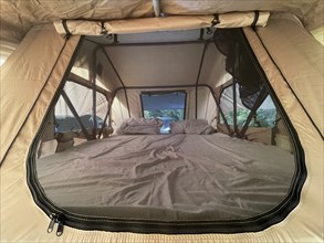 Interior view of a tent with comfortable outdoor sleeping accommodation