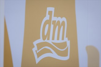 The logo of the drugstore chain DM is stuck on a window front in Berlin, 27/03/2024