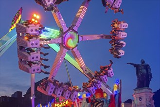 Thrillseekers having fun on fairground attraction during the Gentse Feesten, Ghent city festival,