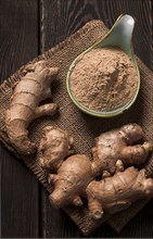 Ground and fresh ginger root, on a wooden table, rustic style, selective focus, no people