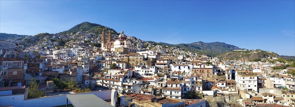 Mexico, Scenic panoramic view of Taxco historic center with colonial houses on the hills and famous