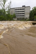 Symbolic image extreme weather, global warming, climate change, flood, flooded weir in Remseck an