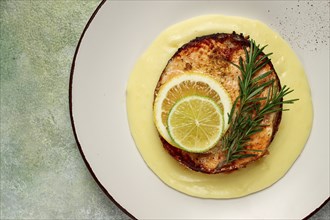 Salmon steak, fried, mashed potatoes, top view, rosemary, lemon and lime, homemade, one serving, no