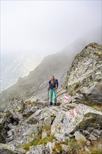 Hiker in the fog, Alpine dangers, Carnic Main Ridge, Carnic High Trail, Carnic Alps, Carinthia,