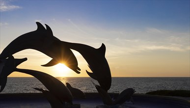 Dolphine silhouettes at Mazatlan sea promenade, El Malecon, with ocean lookouts, tourist beaches