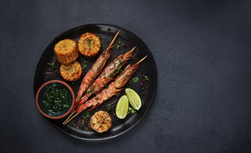 Langoustines on skewers, shrimp kebab, with fried corn, spices and herbs, homemade, no people