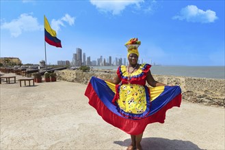 Cartagena, Colombia, 8 May, 2024: Colombia, lady in national colorful costume posing in Walled City