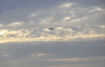 Aeroplane in the distance over a cloudy sky