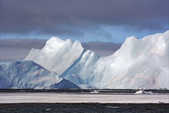 Majestic icebergs rise against the sky in an impressively cool landscape, winter, Ilulissat,