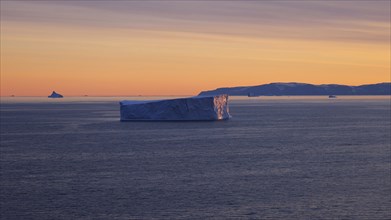 Iceberg seen from cruise ship vacation near Greenland coast in Arctic circle near Ilulissat Disko