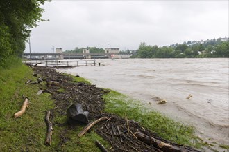 Symbolic image extreme weather, global warming, climate change, flood, washed up wood, barrage on