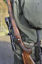 Hunter with shotgun and scope in the Ardennes, Belgium, Europe