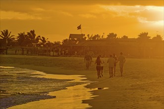 People going for a walk on sandbeach in twilight. Santa Maria. Sal. Cabo Verde. Africa