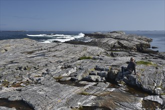 Woman sitting in archipelago in Norway