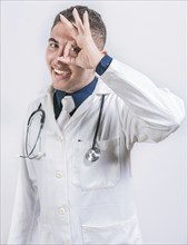 Cheerful doctor gesturing approval isolated. Latin doctor approving on isolated background,