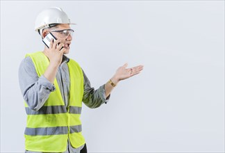 Young engineer calling on cell phone isolated. Civil engineer talking on phone isolated on white