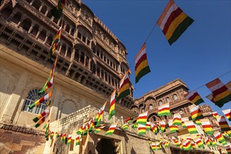 State flags of Jodhpur-Marwar in Meharngarh fort with blue sky. Jodhpur, Rajasthan, India, Asia