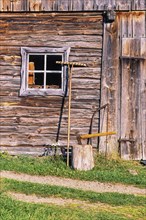 Old timber barn with tools in the countryside, Sweden, Europe