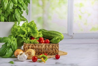 Fresh vegetables in basket, salad ingredients, cucumber, tomatoes, lettuce, basil, pepperoni,