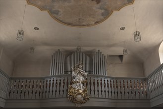 Figure of St. Nepomuk in front of the organ loft in the parish church of St. James the Elder, built