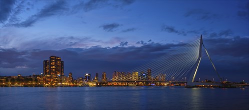 Panorama of Erasmus Bridge (Erasmusbrug) and Rotterdam skyline illuminated at night. Rotterdam,