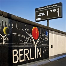 Mural entitled Berlyn on a remnant of the Berlin Wall, artist Gerhard Lahr, with advertising, East